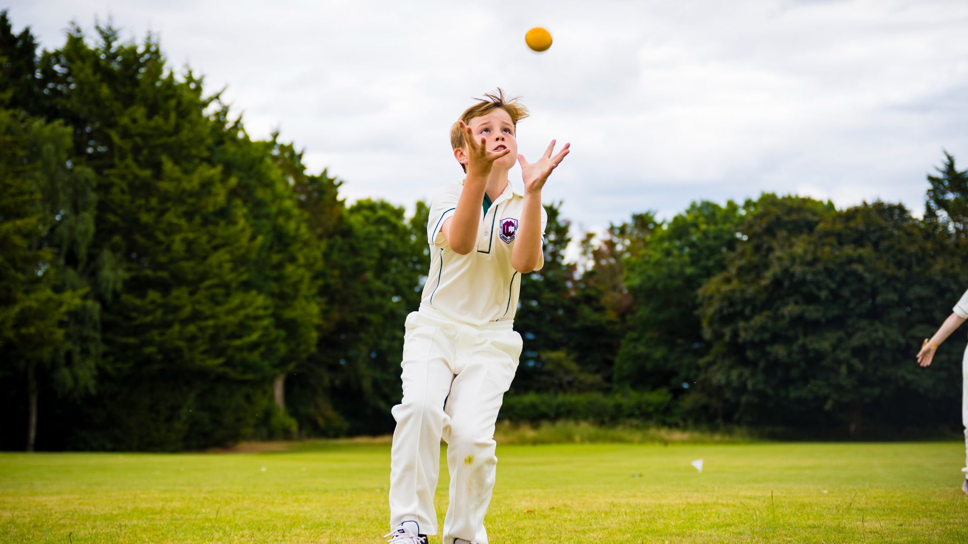 photo of claires court junior boy pupil playin cricket outside