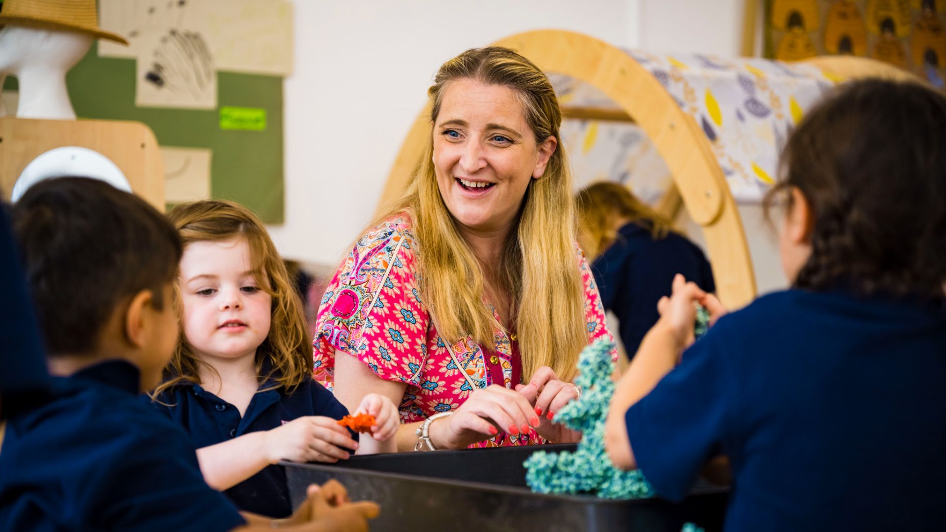A photo of a teacher with claires court nursery pupils