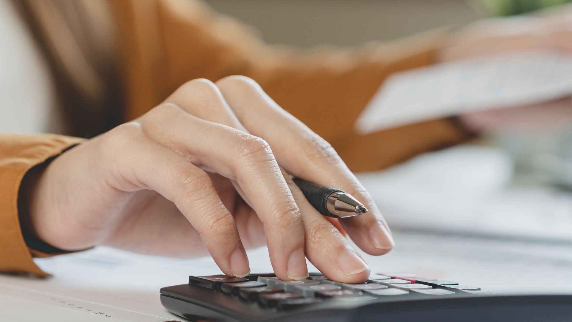 photo of a person using a calculator